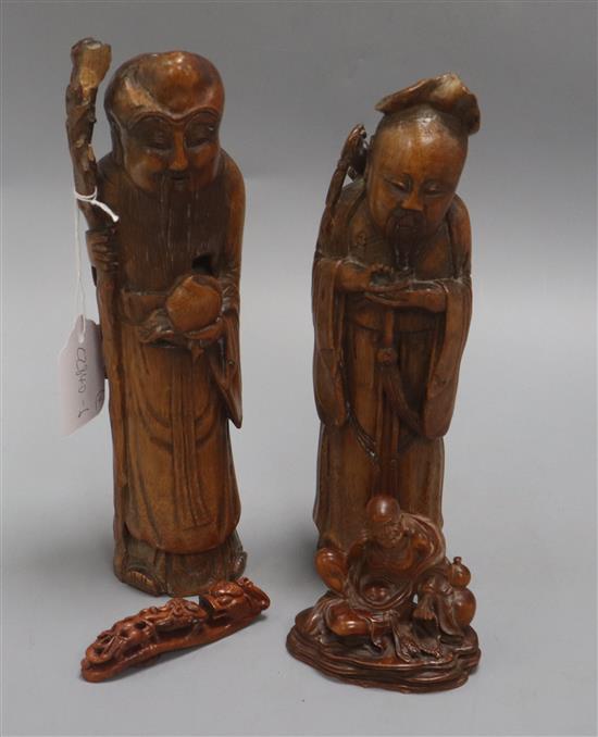 Two Chinese bamboo figures of immortal, a wood figure of a luohan and a wood belt hook tallest 27cm
